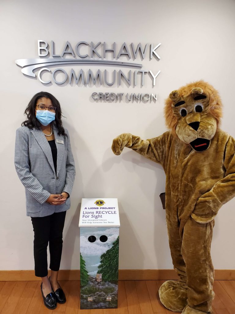 West Court branch manager Diamond Gregory and club mascot Leo the Lion pose with the new eyeglass-recycling dropboxes that have been placed at all four Janesville-area Blackhawk Community Credit Union branches.