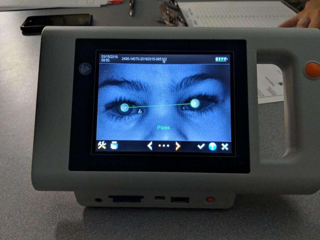 Vision screening camera with passing result