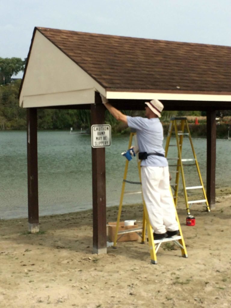 Lion Blaine paints a Lions Beach shelter as part of the Club's Centennial Community Legacy Project.